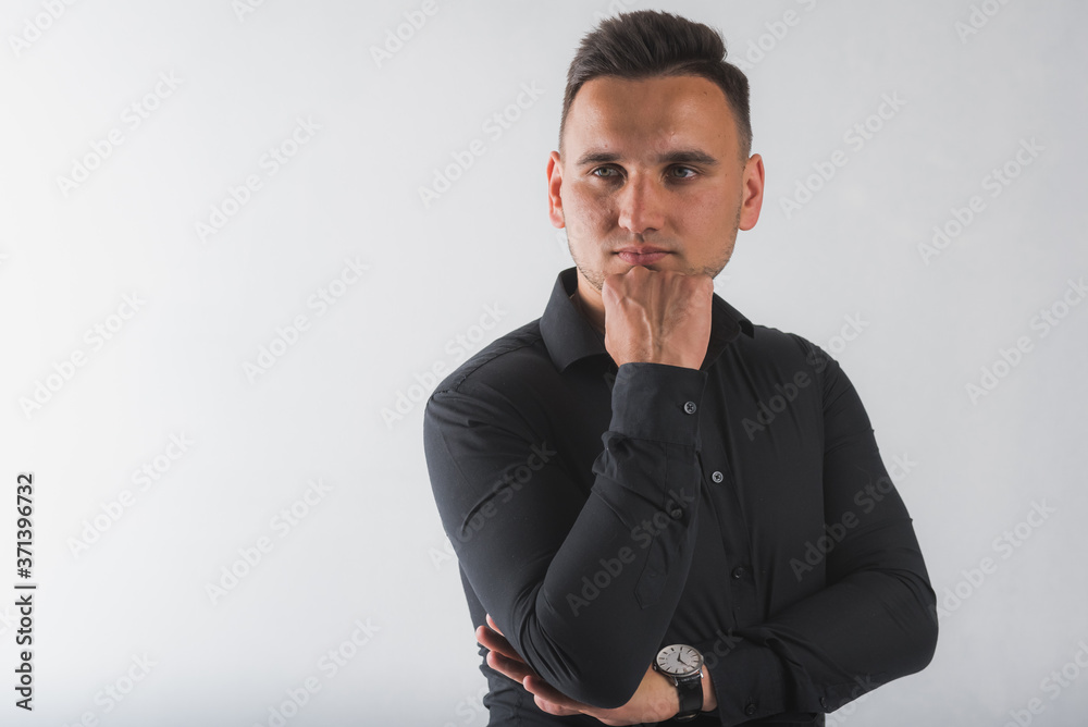 portrait of a young, handsome, round-faced man in a black shirt isolated on a white background, there is room for text portrait of a young, handsome, round-faced man in a black shirt isolated on a white background, there is room for text