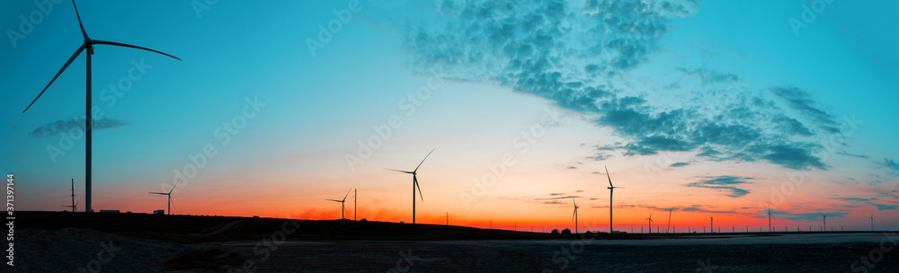 Panorama of wind farm at sunrise