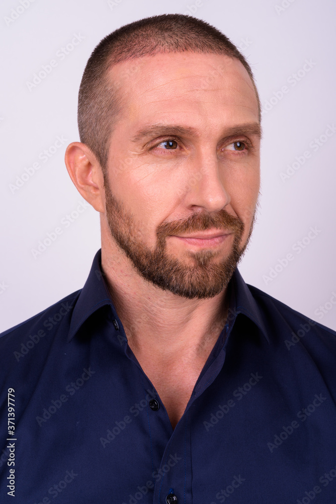 Fototapeta premium Face of handsome bald bearded businessman thinking