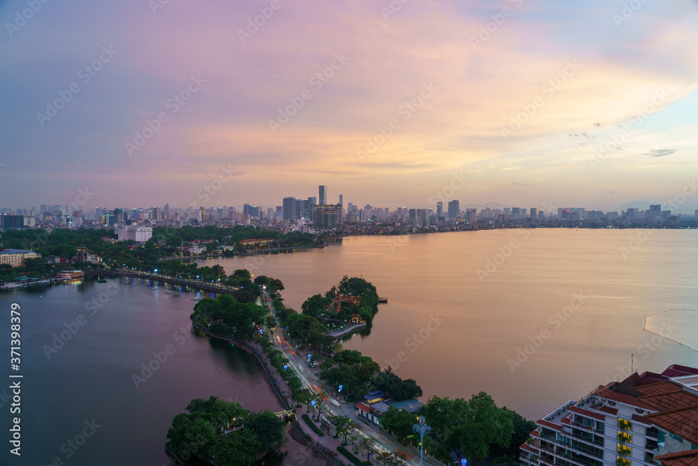 Obraz premium Hanoi cityscape with skyline view during sunset period at West Lake ( Ho Tay ) in 2020