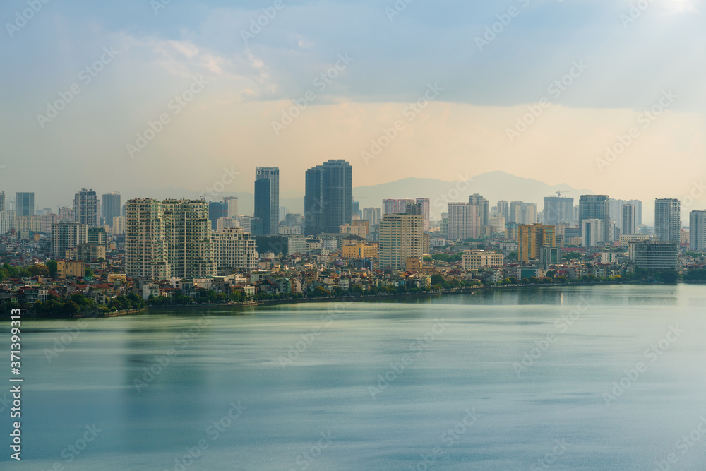 Hanoi cityscape with skyline view during sunset period at West Lake ( Ho Tay ) in 2020 Hanoi cityscape with skyline view during sunset period at West Lake ( Ho Tay ) in 2020