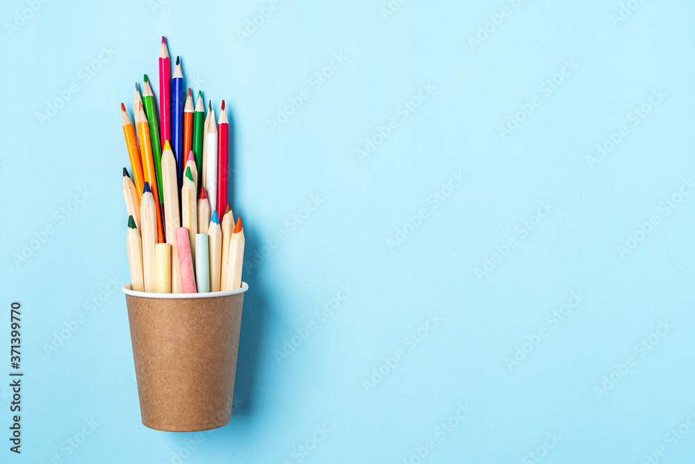 Flat lay Back to school banner with pencil in a cup of coffee. School supplies and stationery, other elements in blue mint empty background with space for text Flat lay Back to school banner with pencil in a cup of coffee. School supplies and stationery, other elements in blue mint empty background with space for text