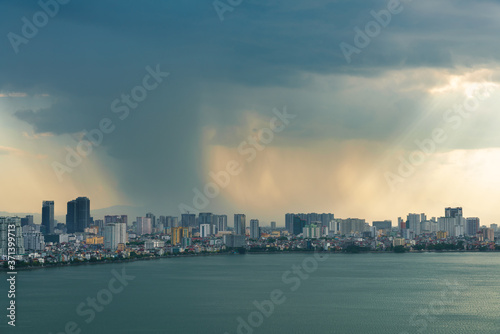 Hanoi cityscape with skyline view during sunset period with dark clouds at West Lake ( Ho Tay ) in 2020 © Hanoi Photography