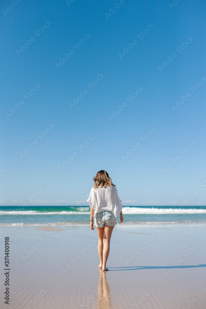 A young woman walking at the beach