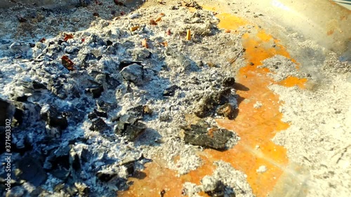 Ash. Cigarettes in the ash. Coal.