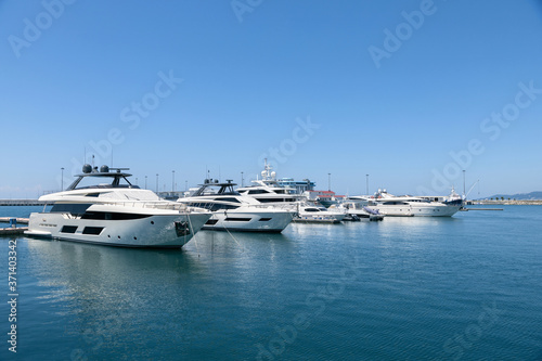 Beautiful view of luxury private yachts in the tropical sea on a sunny day. Ships and boats are moored at the pier..