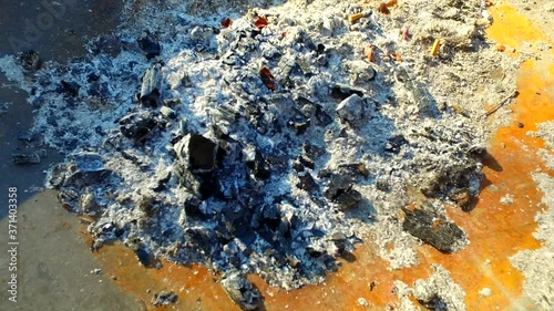 Ash. Cigarettes in the ash. Coal.