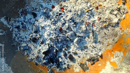 Ash. Cigarettes in the ash. Coal.