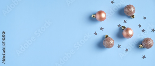 Christmas banner mockup. Xmas balls and sparkling decorations on blue background with copy space.