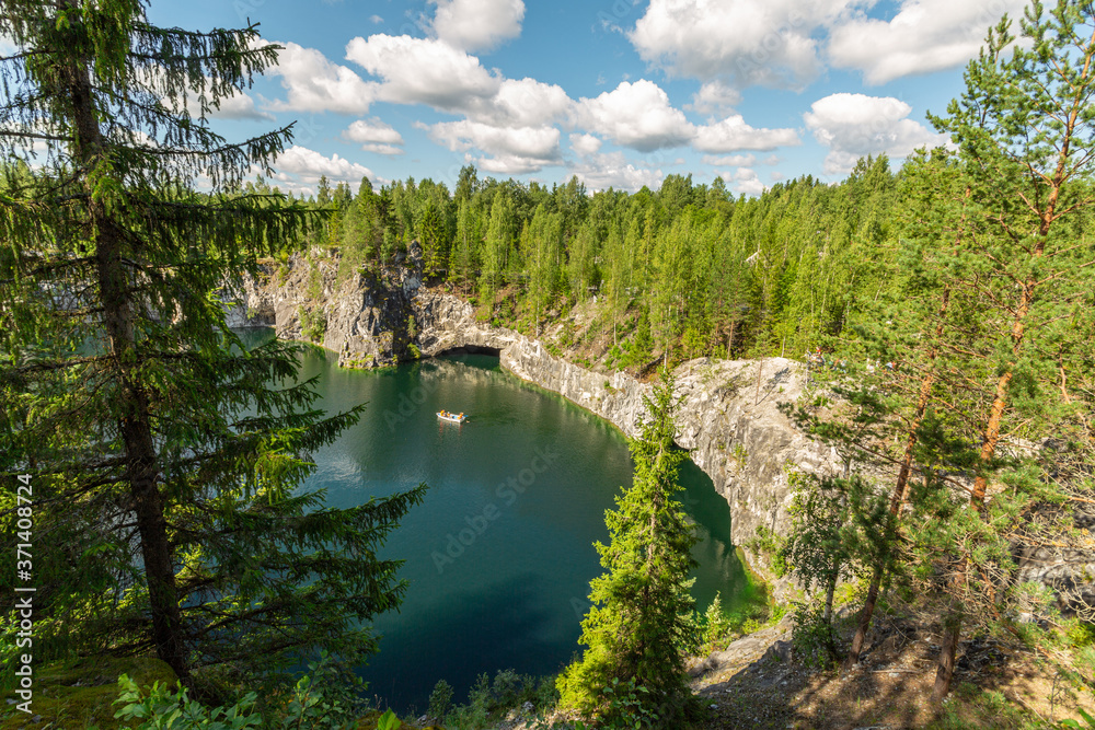 Top view upon the lake with the tourist boat in Marble Canyon, Ruskeala, Karelia. Horizontal image.