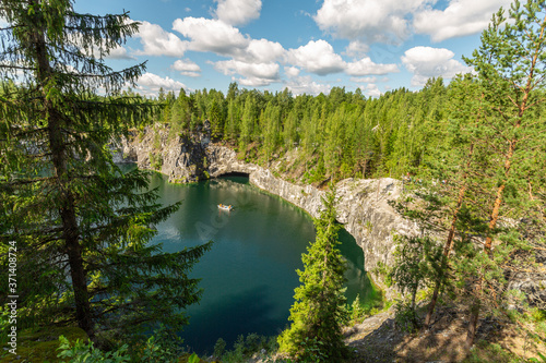 Top view upon the lake with the tourist boat in Marble Canyon, Ruskeala, Karelia. Horizontal image.