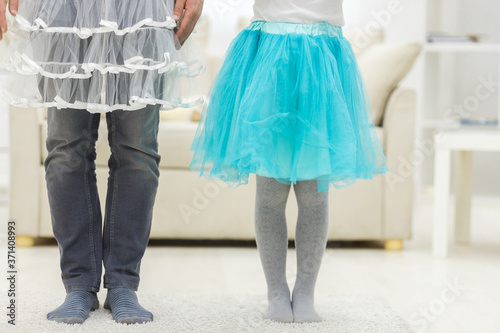 Photo of father and daughter's legs wearing funny clothes.