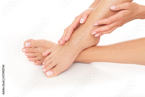 Female hands and feet on white background. Studio shoot.