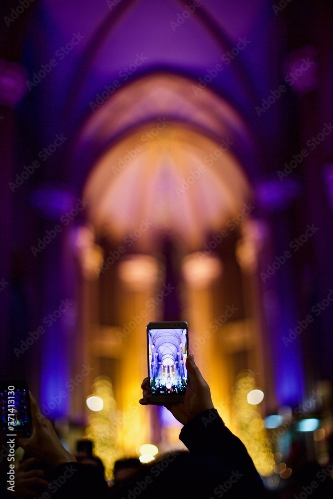 people is taking a photo in the church by using smart phone 