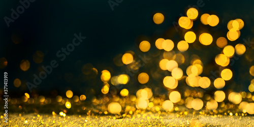 Abstract blur golden glitter border on black background. Luxury card design for new year, christmas and wedding celebration. Party bokeh sparkle confetti textured layou photo