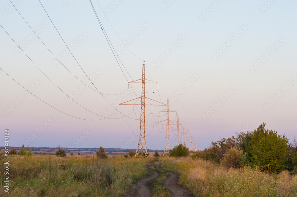 Fototapeta premium outgoing dirt road against the background of the power line