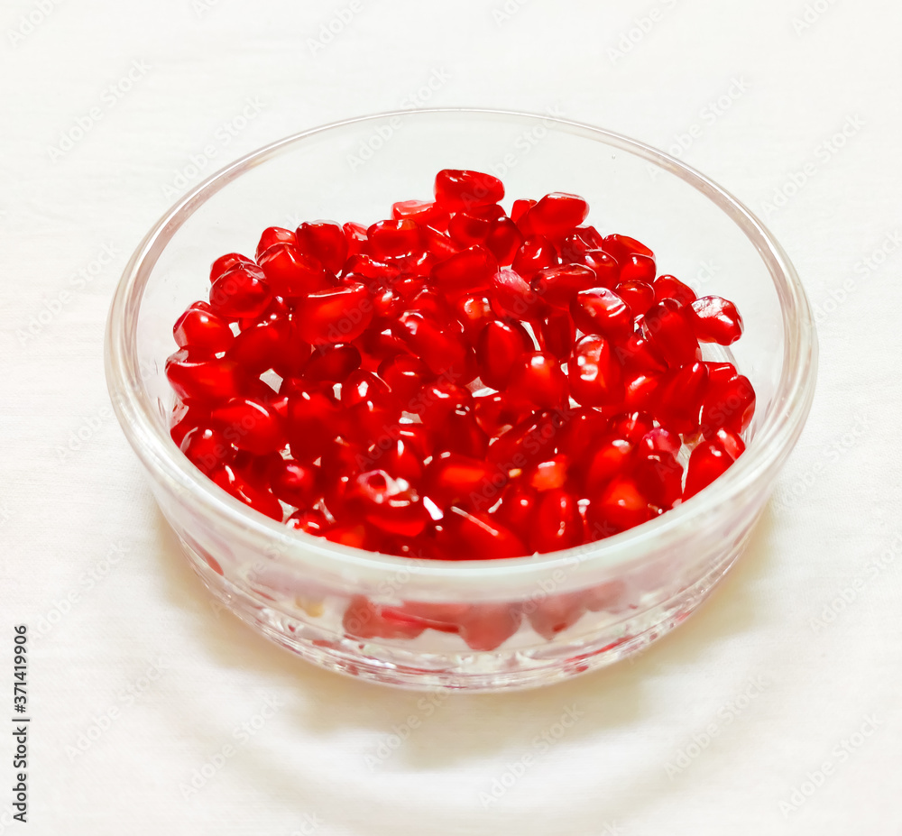 pomegranate seeds served in a crystal bowl pomegranate seeds served in a crystal bowl