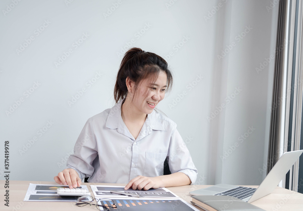 Portrait beautiful asian businesswoman working in her home, office, looking at graphs, financial markets, her business, and paying much attention. Portrait beautiful asian businesswoman working in her home, office, looking at graphs, financial markets, her business, and paying much attention.