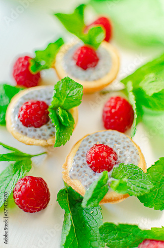 Fototapeta Naklejka Na Ścianę i Meble -  light summer dietary dessert (proper nutrition) is a tart with chia seeds, raspberries and mint. Healthy food for those who look after their figure