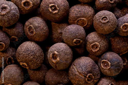 super macro shot of allspice dry pepper in detail very close. food spice background..