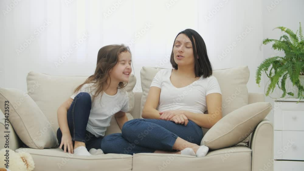 Daughter and mother are playing around, pushing each other, roaring at each other. Daughter and mother are playing around, pushing each other, roaring at each other.