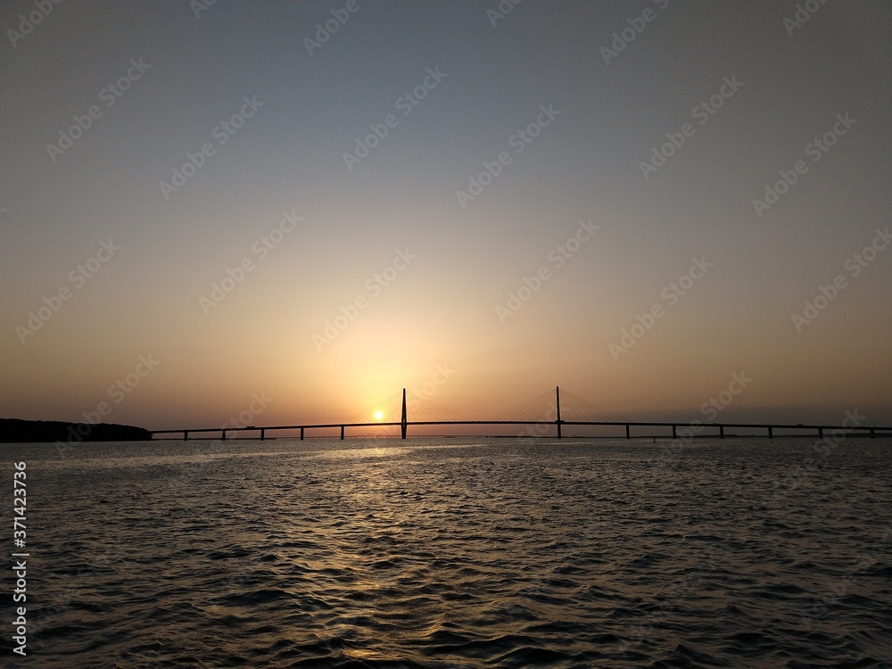 sunset over the sea and bridge
