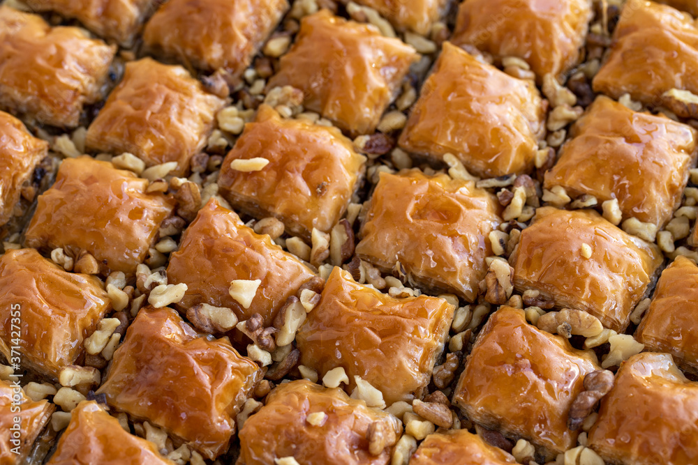 Baklava with walnut standing on the tray Baklava with walnut standing on the tray
