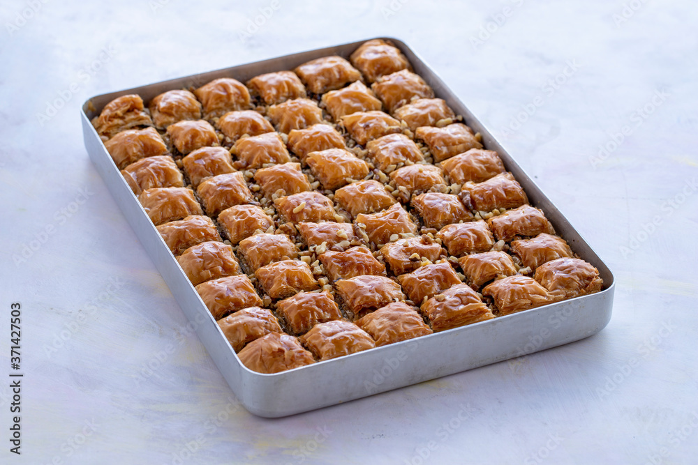 Baklava with walnut standing on the tray Baklava with walnut standing on the tray