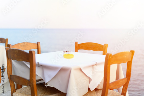 cafe tables on the sea mediterranean embankment. selective focus. flare
