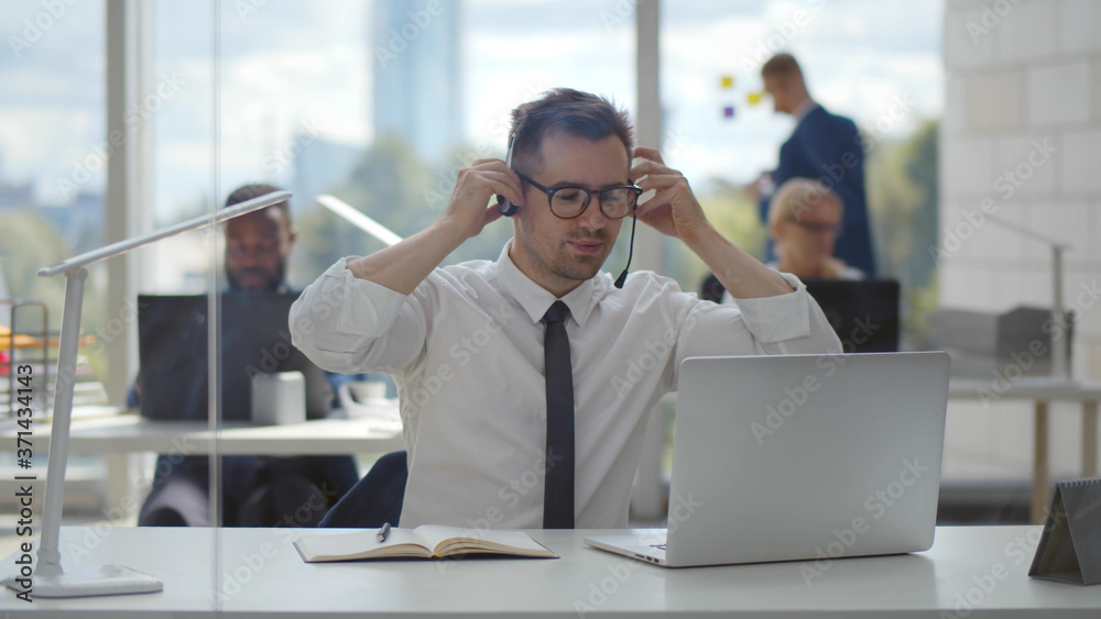 Young businessman finishing video conference with customer on laptop