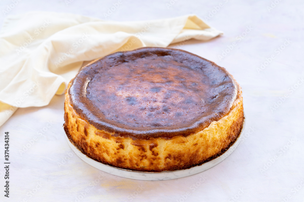 Fototapeta premium San Sebastian Cheesecake on White Wood