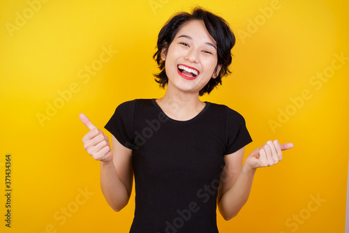 Bild auf Leinwand Closeup of young optimistic female isolated on grey background showing thumbs up with positive emotions of content and happiness