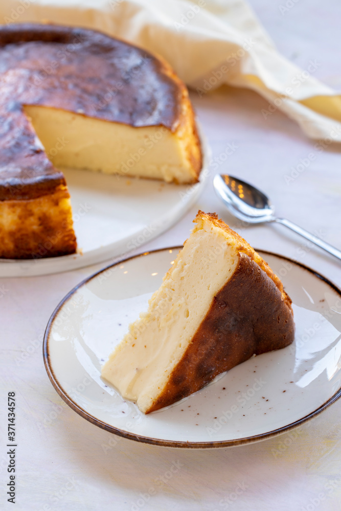 Fototapeta premium San Sebastian Cheesecake on White Wood