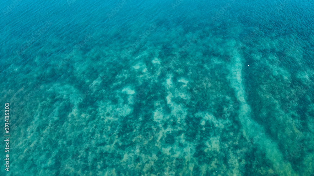 Fototapeta premium Beach and bright blue sea, high angle view