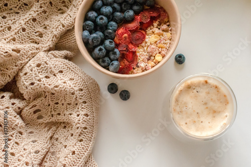 Breakfast with granola, coffee and cakes