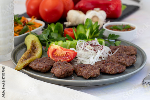 Delicious Turkish traditional kebab meatballs on white plate. Turkish Food Kofte or Kofta (meatball).
