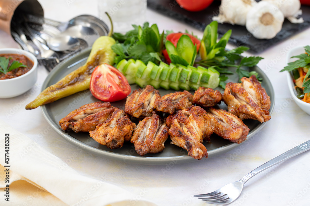 Chicken wings on the grill. Grilled chicken wings on a white background