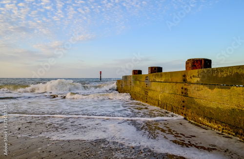Wooden groyne/breaker in the North Sea used to defend the fragile cliffs from coastal erosion.