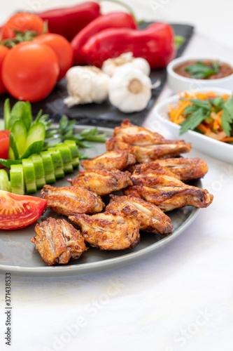 Chicken wings on the grill. Grilled chicken wings on a white background