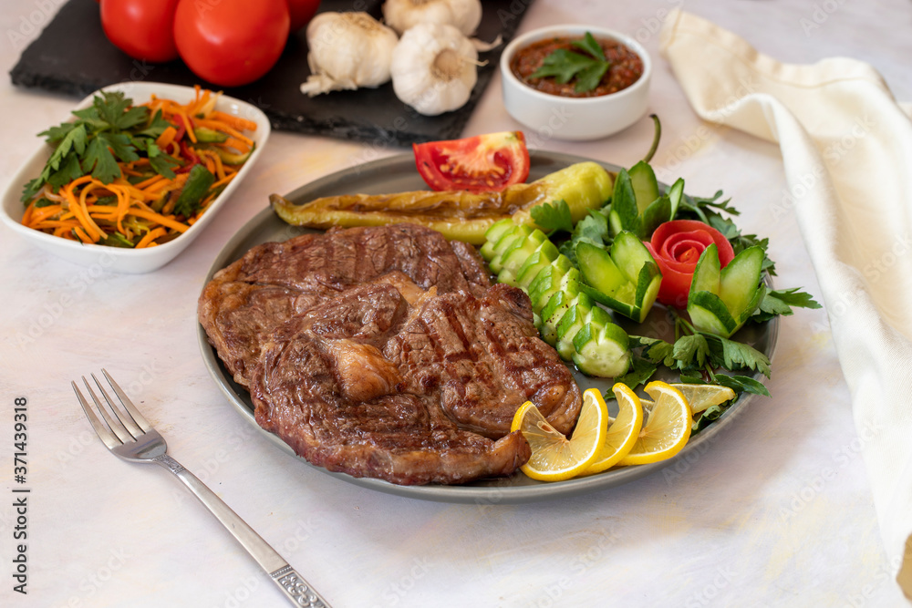 Isolated grilled beef steak on a wooden board Isolated grilled beef steak on a wooden board