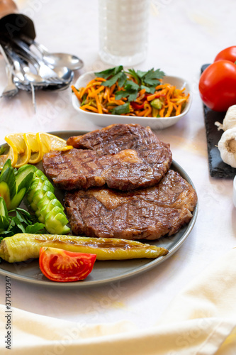 Isolated grilled beef steak on a wooden board