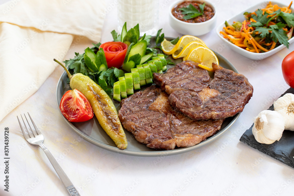 Isolated grilled beef steak on a wooden board Isolated grilled beef steak on a wooden board
