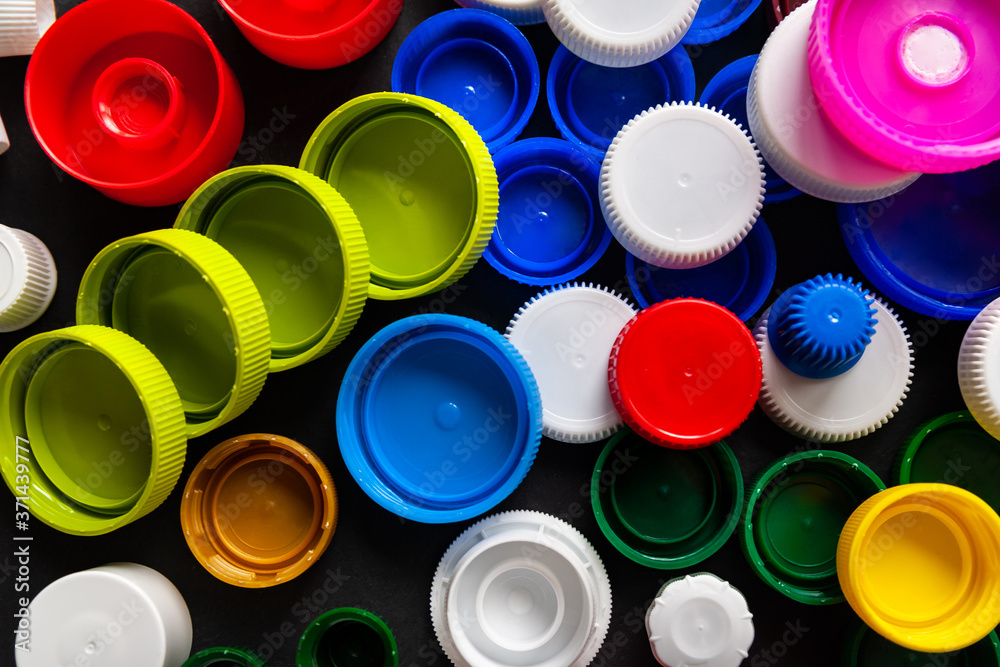 A lot of plastic bottle caps. Top view of bottle caps made of recycled