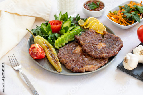 Isolated grilled beef steak on a wooden board