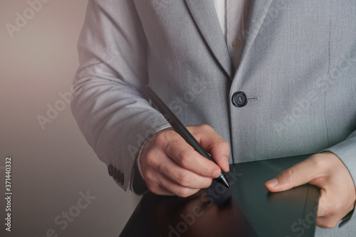 Man in suit signing digital contract