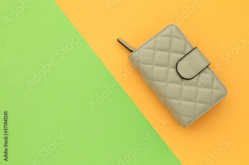 New woman bag or wallet on orange color background with copy space for text or design