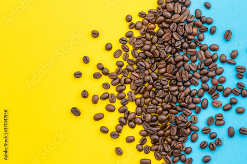 Pile of coffee grain on yellow background. Coffee and food concept