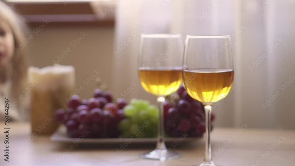 Two glasses of white wine and berries. Yellow juice. Apple drink. Cocktail in glasses. Grapes. High quality FullHD footage Two glasses of white wine and berries. Yellow juice. Apple drink. Cocktail in glasses. Grapes. High quality FullHD footage