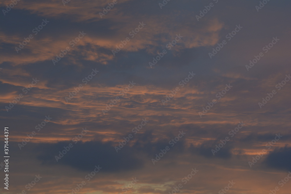 Cloudy and colorful sky on a summer evening over a city