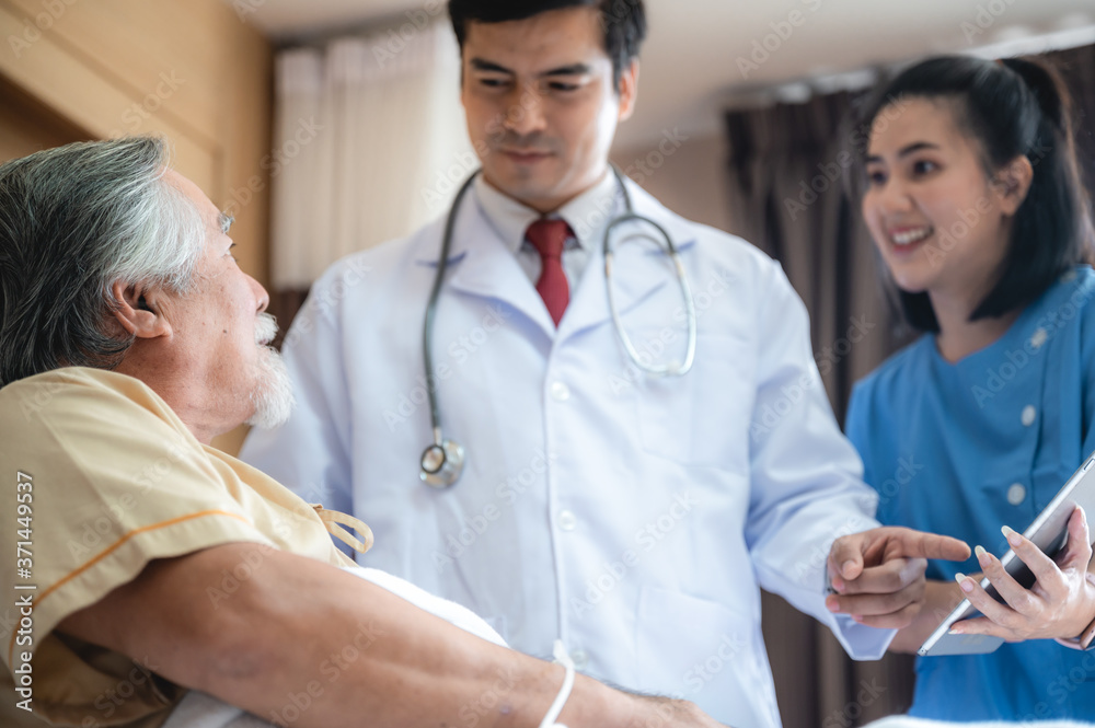 Doctor talking to elderly senior male patient